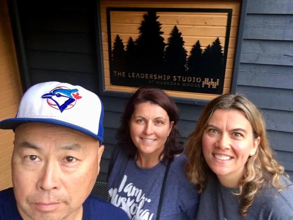 Three volunteers taking a group photo outside the Leadership Studio